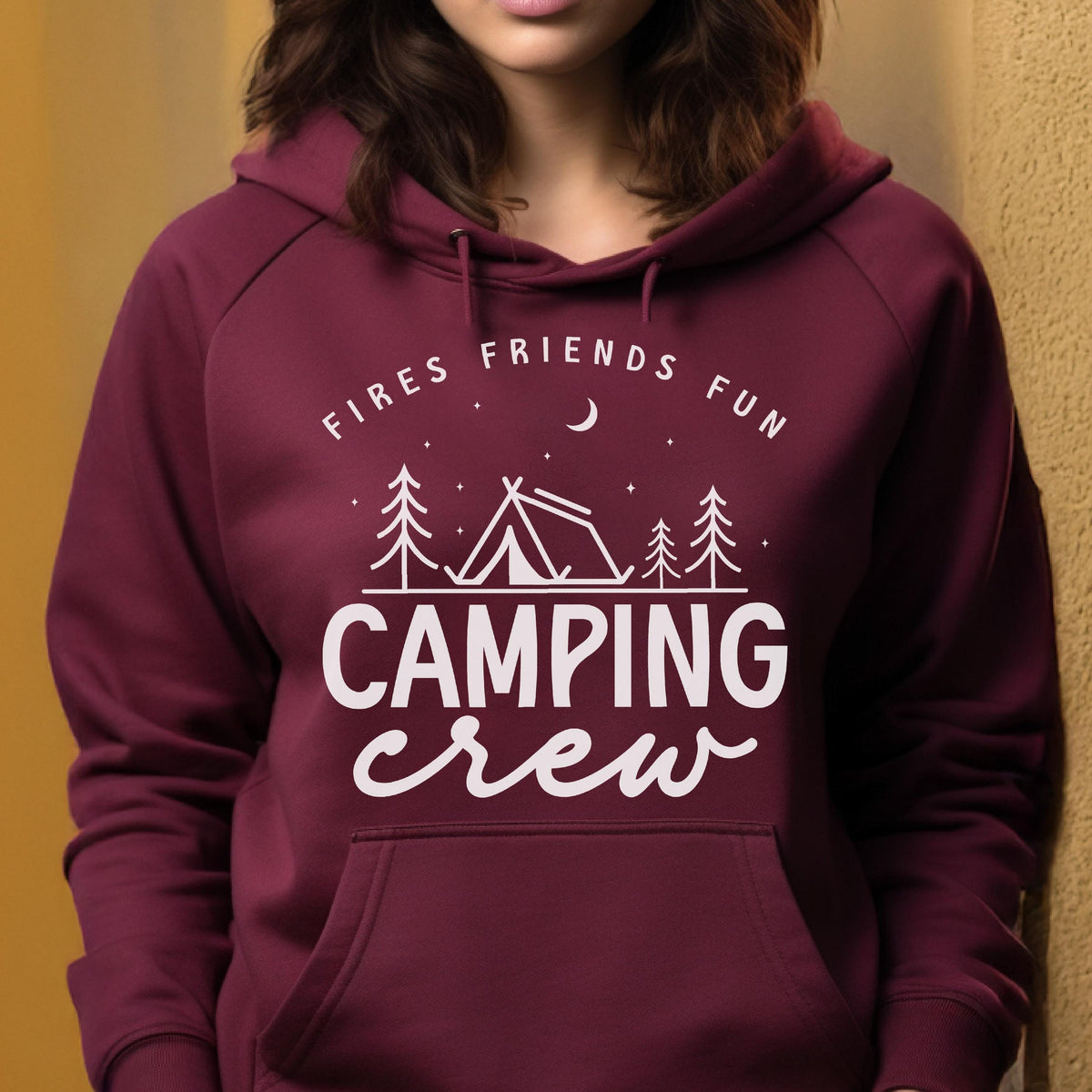 May include: A maroon hoodie with a white graphic that says "FIRES FRIENDS FUN" above a tent and trees, with the words "CAMPING crew" below. The hoodie has a front pocket and a hood.