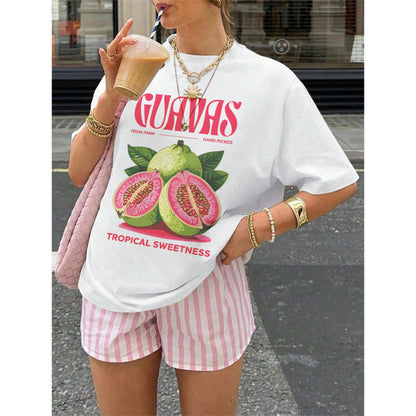 May include: White t-shirt with a guava fruit graphic and the text "GUAVAS" in red. The shirt also features the text "FROM FARM HAND PICKED TROPICAL SWEETNESS". The shirt is paired with pink and white striped shorts.