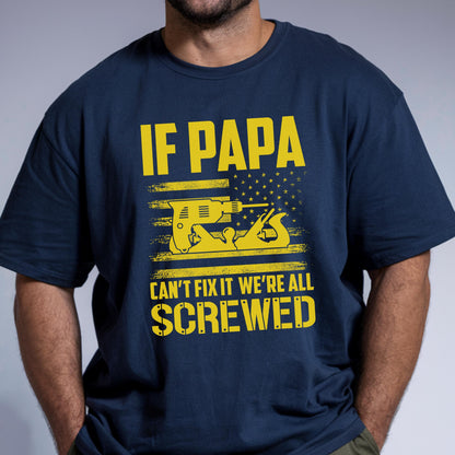 May include: Navy blue t-shirt with yellow text and graphics. The text reads "IF PAPA CAN'T FIX IT WE'RE ALL SCREWED" above an illustration of a drill and a hand plane, with an American flag design.