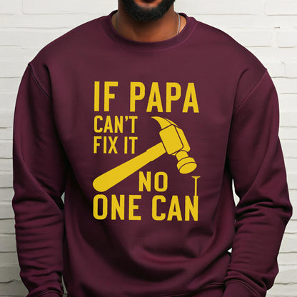 May include: Burgundy sweatshirt with a yellow graphic of a hammer and the text "IF PAPA CAN'T FIX IT NO ONE CAN". The design is centered on the front of the long-sleeved crew neck shirt.