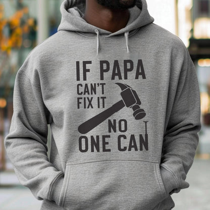 May include: A gray hoodie with the text "IF PAPA CAN'T FIX IT NO ONE CAN" in black. A black hammer graphic is positioned above a nail graphic. The hoodie has a drawstring and a front pocket.
