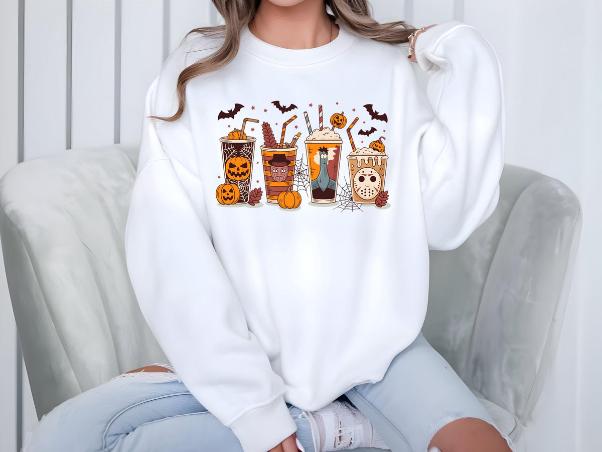 May include: White sweatshirt featuring a Halloween-themed design. The graphic includes four illustrated cups with spooky characters and pumpkins. Bats are scattered above the cups. The sweatshirt is a comfortable, casual style.