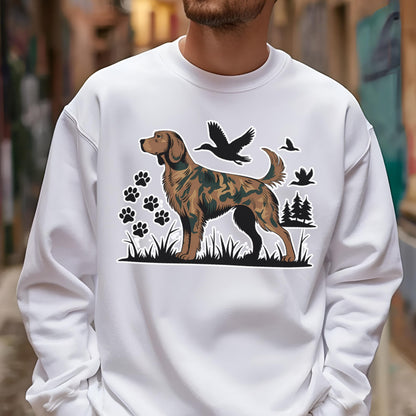 May include: White sweatshirt featuring a brown and green camouflage dog graphic, paw prints, flying birds, and trees. The dog illustration is standing in grass. The sweatshirt is a casual style.