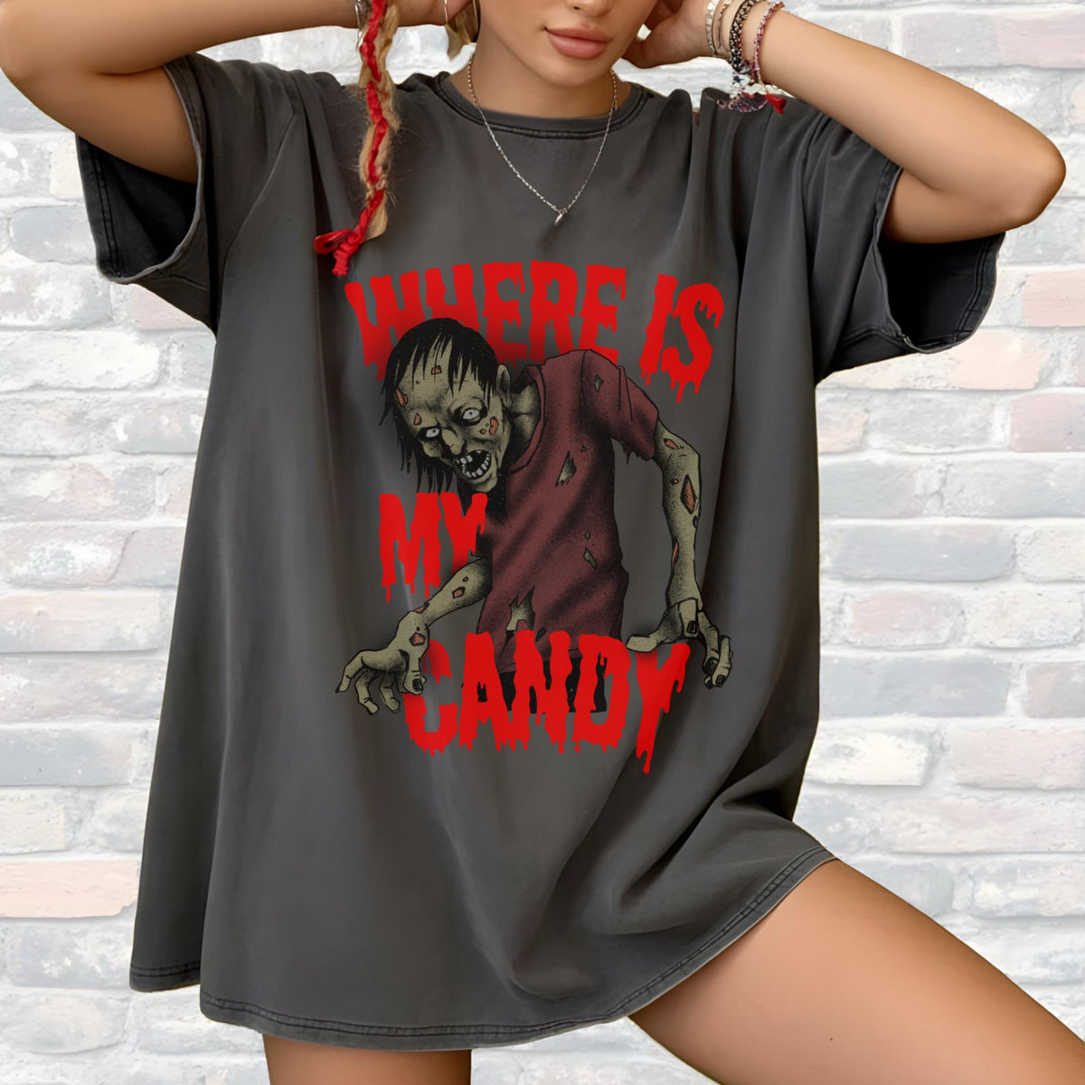 May include: Dark gray t-shirt featuring a zombie graphic in red and maroon. The text "WHERE IS MY CANDY" is printed above and below the zombie illustration. The shirt has a relaxed fit.