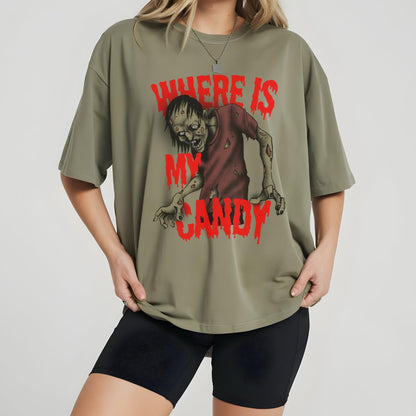 May include: Olive green t-shirt featuring a zombie graphic with the text "WHERE IS MY CANDY" in red. The zombie is depicted in a distressed style, with a red shirt and exposed flesh. The shirt has short sleeves and a relaxed fit.