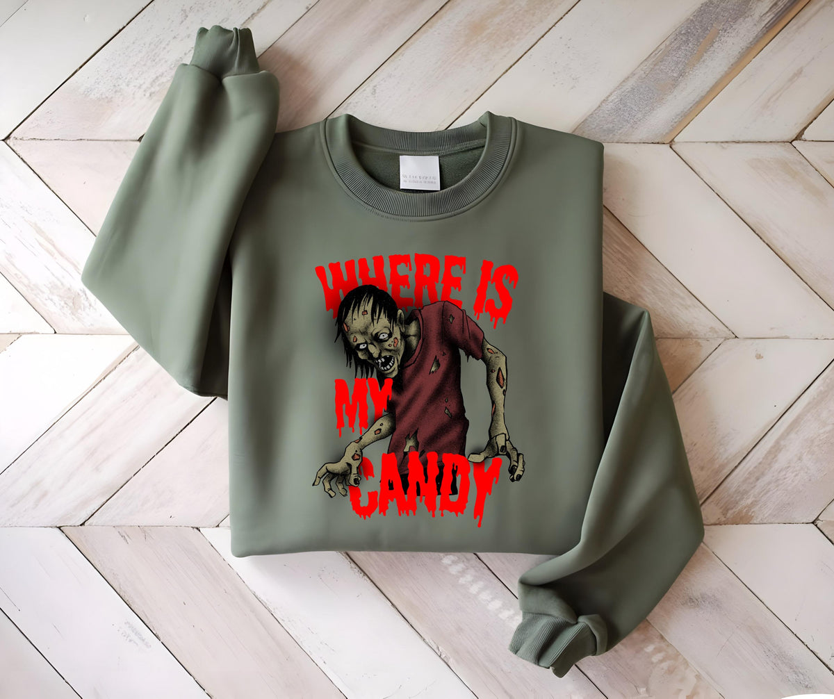 May include: An olive green sweatshirt featuring a graphic of a zombie with the text "WHERE IS MY CANDY" in red. The zombie is depicted with a red shirt and exposed flesh. The sweatshirt has a crew neck and long sleeves.