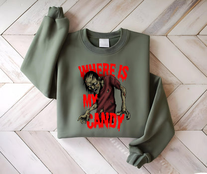 May include: An olive green sweatshirt featuring a graphic of a zombie with the text "WHERE IS MY CANDY" in red. The zombie is depicted with a red shirt and exposed flesh. The sweatshirt has a crew neck and long sleeves.