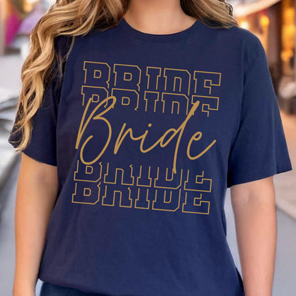 May include: Navy blue t-shirt with the word "Bride" in gold lettering. The word is repeated multiple times in a stacked design. The shirt is a crew neck and has short sleeves.