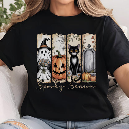 May include: A black t-shirt featuring a graphic print divided into four vertical panels. The panels display a ghost in a witch hat holding flowers, a jack-o'-lantern with a spider web, a black cat with daisies, and a tombstone. The text Spooky Season is below.