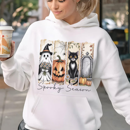 May include: A white hooded sweatshirt featuring a graphic print of four vertical panels with a ghost in a witch hat, a jack-o'-lantern, a black cat, and a tombstone. The text Spooky Season is printed in a cursive font below the panels.