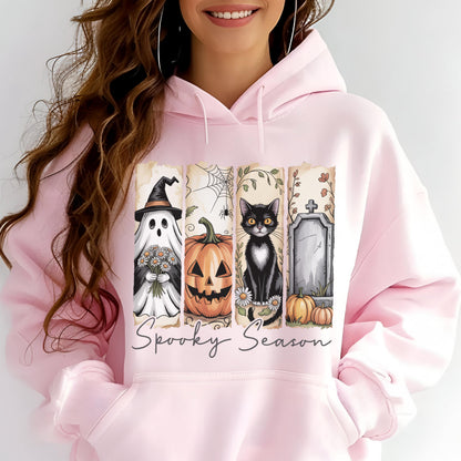 May include: A light pink hooded sweatshirt featuring a graphic print of four vertical panels with a ghost holding flowers, a jack-o'-lantern, a black cat, and a tombstone. The text Spooky Season is printed in a cursive font below the panels.
