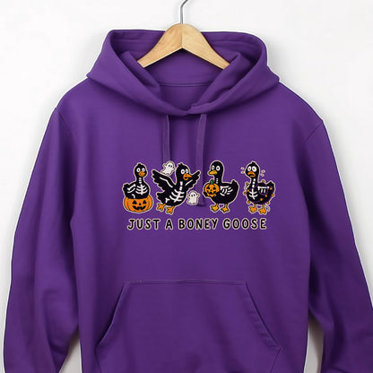 May include: A purple hoodie featuring a Halloween-themed graphic. The graphic includes four cartoon ducks with skeleton designs, pumpkins, and ghosts. The text "JUST A BONEY GOOSE" is printed below the graphic.