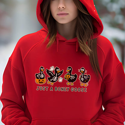 May include: A red hooded sweatshirt featuring a Halloween-themed graphic. The graphic includes four cartoon geese with skeleton designs, pumpkins, and ghosts. The text "JUST A BONEY GOOSE" is printed below the geese.