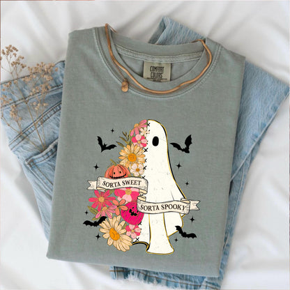 May include: Sage green Comfort Colors t-shirt featuring a ghost design. The ghost is half-floral and half-white, with the text "Sorta Sweet Sorta Spooky" on a banner. The design includes bats, a pumpkin, and flowers.