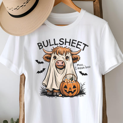 May include: White t-shirt featuring a Halloween-themed graphic. The design includes a cow dressed as a ghost with the text "BULLSHEET" above and "Moo... I mean boo" below. A jack-o'-lantern and bats complete the design.