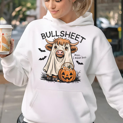 May include: White hoodie with a Halloween-themed graphic. The design features a cow in a ghost costume, a jack-o'-lantern, and the text "BULLSHEET" above the cow and "Moo... I mean boo" to the right. Black bats are also included.