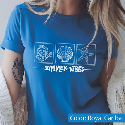 May include: Royal Cariba blue t-shirt with a white graphic of a coral, seashell, and starfish. The words "SUMMER VIBES" are printed below the images. The shirt has short sleeves.