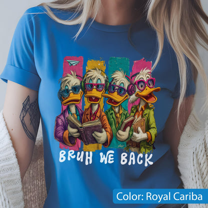 May include: Royal Cariba blue t-shirt featuring a cartoon illustration of four ducks wearing glasses and headphones, each holding a book. The text "BRUH WE BACK" is printed in white below the illustration.