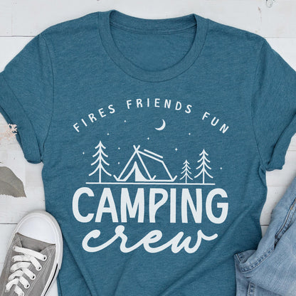 May include: Teal t-shirt with the words "Fires Friends Fun" above a camping scene with a tent and trees, and the words "Camping Crew" below. A gray sneaker and denim jeans are visible in the image.
