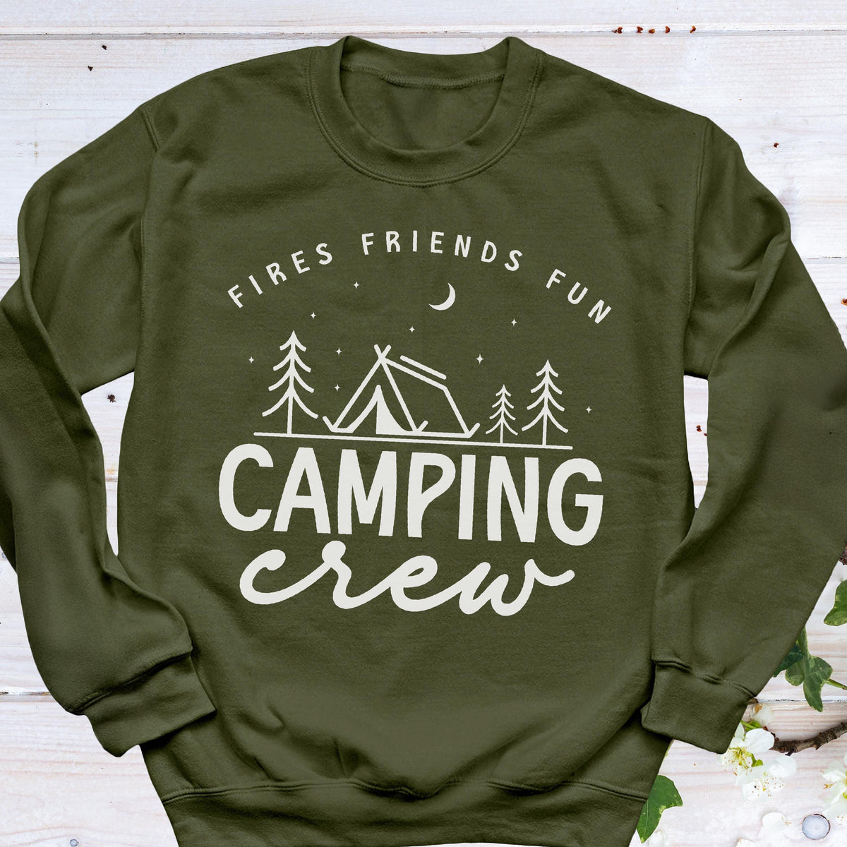 May include: An olive green sweatshirt with the words "Fires Friends Fun" above a camping scene with a tent and trees. Below the scene, the words "Camping Crew" are written in a cursive font.