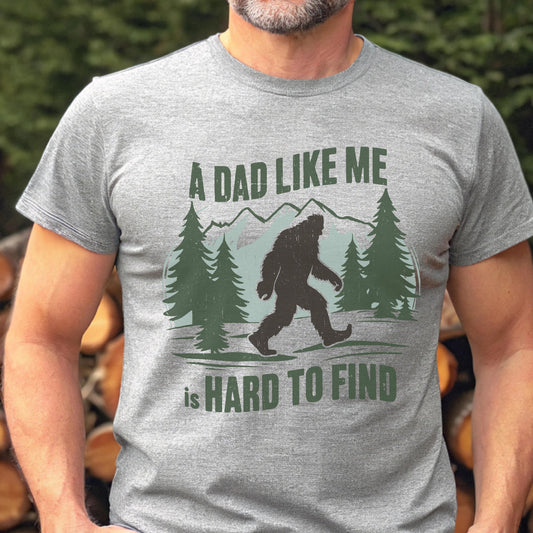 Funny Bigfoot Dad Shirt, A Dad Like Me Is Hard To Find Tee, Sasquatch Father’s Day Gift, Wilderness Dad T-Shirt, Forest Style Tees