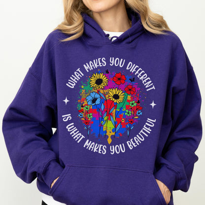 May include: A purple hoodie with a floral design and the text "WHAT MAKES YOU DIFFERENT IS WHAT MAKES YOU BEAUTIFUL" in white. The floral design includes sunflowers, red flowers, and blue flowers.