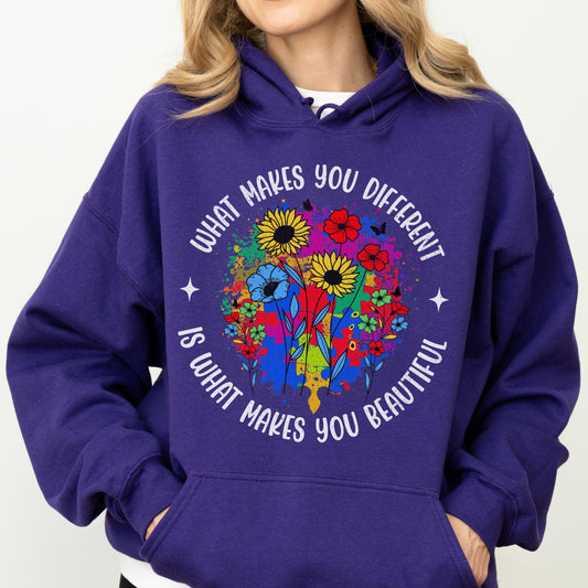 May include: A purple hoodie with a floral design and the text "WHAT MAKES YOU DIFFERENT IS WHAT MAKES YOU BEAUTIFUL" in white. The floral design includes sunflowers, red flowers, and blue flowers.