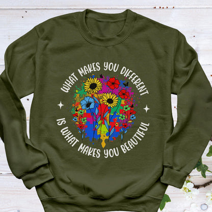 May include: An olive green sweatshirt with a colorful floral design. The design features sunflowers, red flowers, and blue flowers, with the text "WHAT MAKES YOU DIFFERENT IS WHAT MAKES YOU BEAUTIFUL" in a circular pattern.