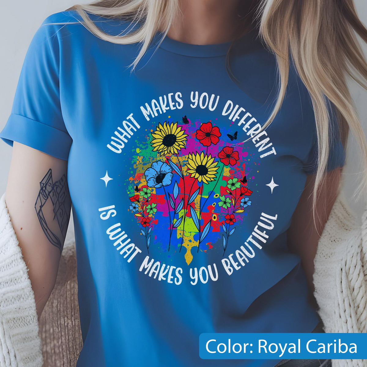 May include: Royal Cariba blue t-shirt with a colorful floral design. The design includes sunflowers, red flowers, and blue flowers, with the text "WHAT MAKES YOU DIFFERENT IS WHAT MAKES YOU BEAUTIFUL".
