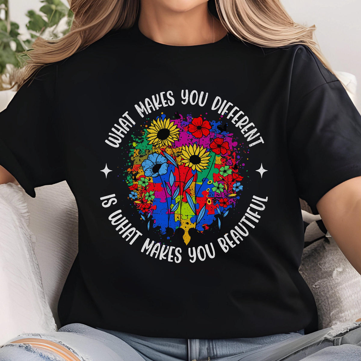 May include: Black t-shirt with a colorful floral design and the text "WHAT MAKES YOU DIFFERENT IS WHAT MAKES YOU BEAUTIFUL". The design includes sunflowers, red flowers, and blue flowers.