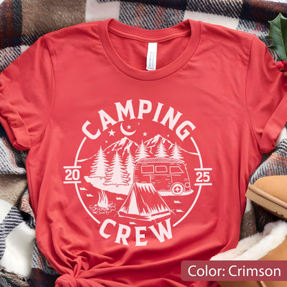 May include: A crimson short-sleeve t-shirt featuring a white circular graphic with the text CAMPING CREW, the numbers 20 and 25, a camper van, a tent, a campfire, pine trees, mountains, stars, and a crescent moon centered on the chest.