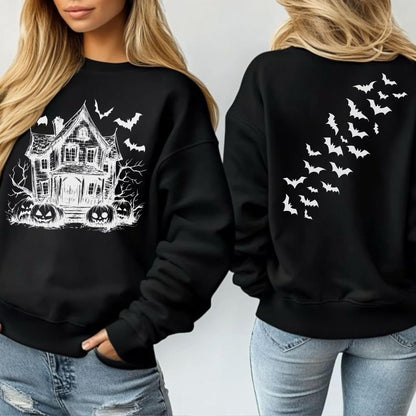 May include: Black sweatshirt featuring a white haunted house, bats, and jack-o'-lanterns graphic on the front. The back of the sweatshirt has a white bat design. A Halloween-themed apparel item.
