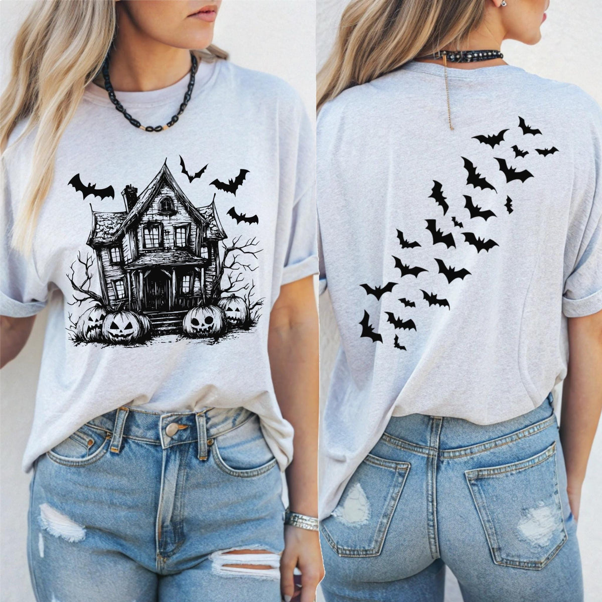 May include: Light gray t-shirt featuring a black graphic of a haunted house, bats, and jack-o'-lanterns on the front. The back of the shirt has a design of bats in flight. The shirt is paired with blue jeans.