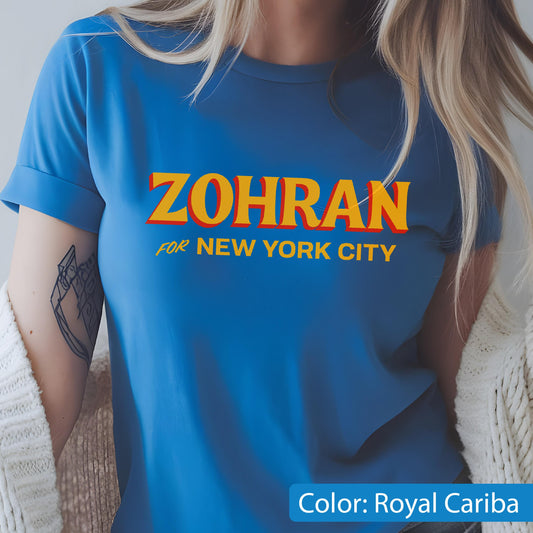 May include: Royal Cariba blue t-shirt with the word "ZOHRAN" in yellow and orange lettering, and the text "FOR NEW YORK CITY" below. The shirt has rolled-up sleeves.