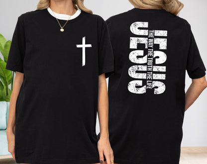May include: Black t-shirt with a white cross graphic on the front and the text "JESUS THE WAY THE TRUTH THE LIFE" on the back. The shirt has a crew neck and short sleeves. The text and cross have a distressed, textured appearance.