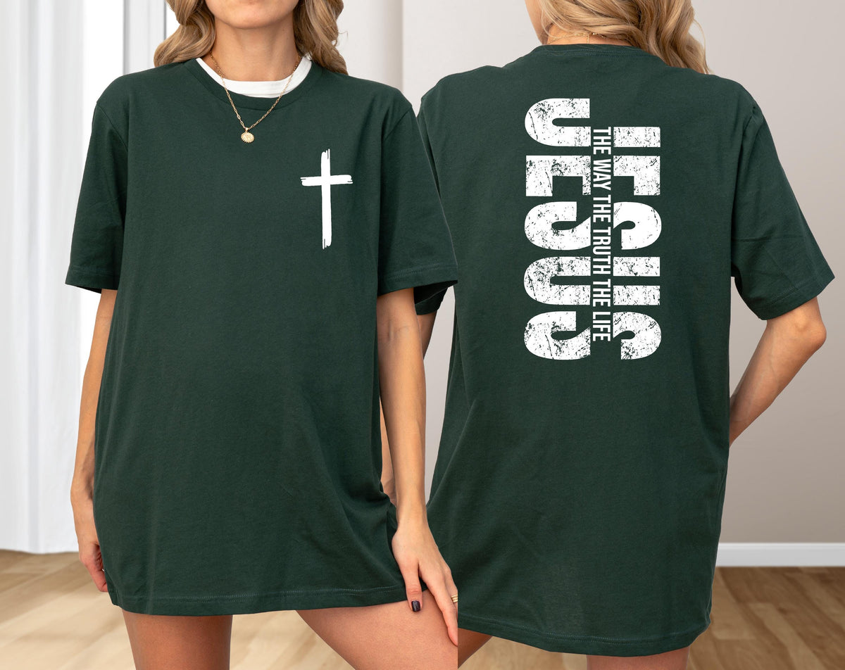 May include: Dark green t-shirt with a white cross on the front. The back of the shirt features the word "JESUS" in large white letters, with "THE WAY THE TRUTH THE LIFE" printed below.