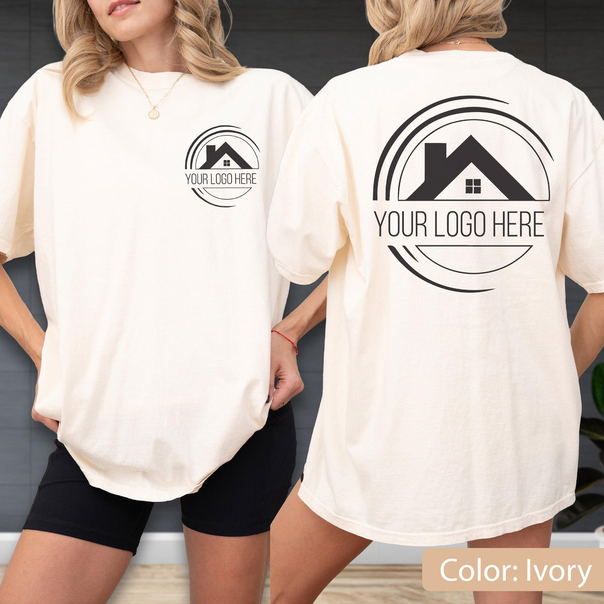 May include: Ivory-colored t-shirt with a black logo on the front and back. The logo features a house silhouette within a circular design, with the text "YOUR LOGO HERE" below. The shirt is a relaxed fit.