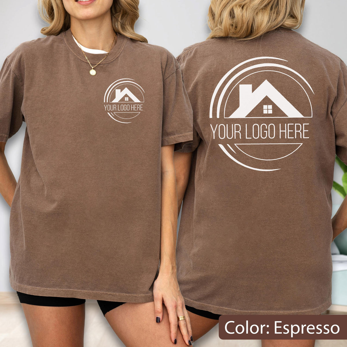 May include: Espresso-colored t-shirt with a white logo on the front and back. The logo features a house silhouette within a circular design, with the text "YOUR LOGO HERE". The shirt is a short-sleeved, casual style.