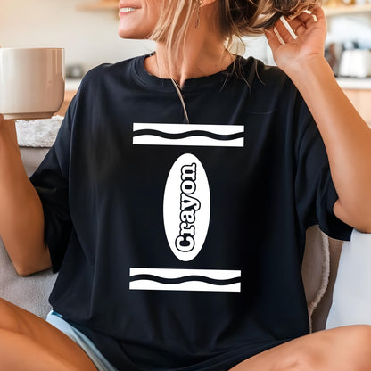 May include: A black short-sleeved t-shirt featuring a white graphic print on the chest. The design consists of two horizontal wavy lines above and below a central vertical oval containing the word Crayon in a bold, white, rounded font.