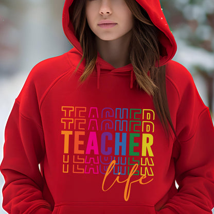 May include: A red hooded sweatshirt with the word "TEACHER" stacked in colorful block letters. Below the word "TEACHER" is the word "life" in a cursive font. The sweatshirt is made of a soft material.
