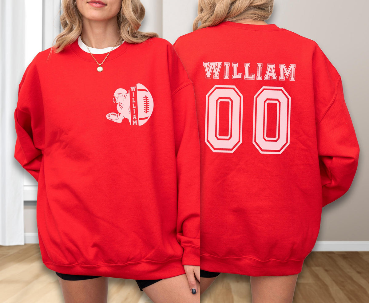 May include: A bright red crewneck sweatshirt featuring a white graphic on the left chest of a football player and a football with the name WILLIAM. The back displays the name WILLIAM in white block letters above the large white jersey number 00.