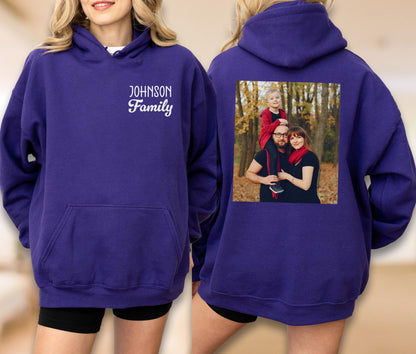 May include: A purple hooded sweatshirt with a front pocket and the text "Johnson Family" in white script. The back of the sweatshirt features a family photo in a square frame.