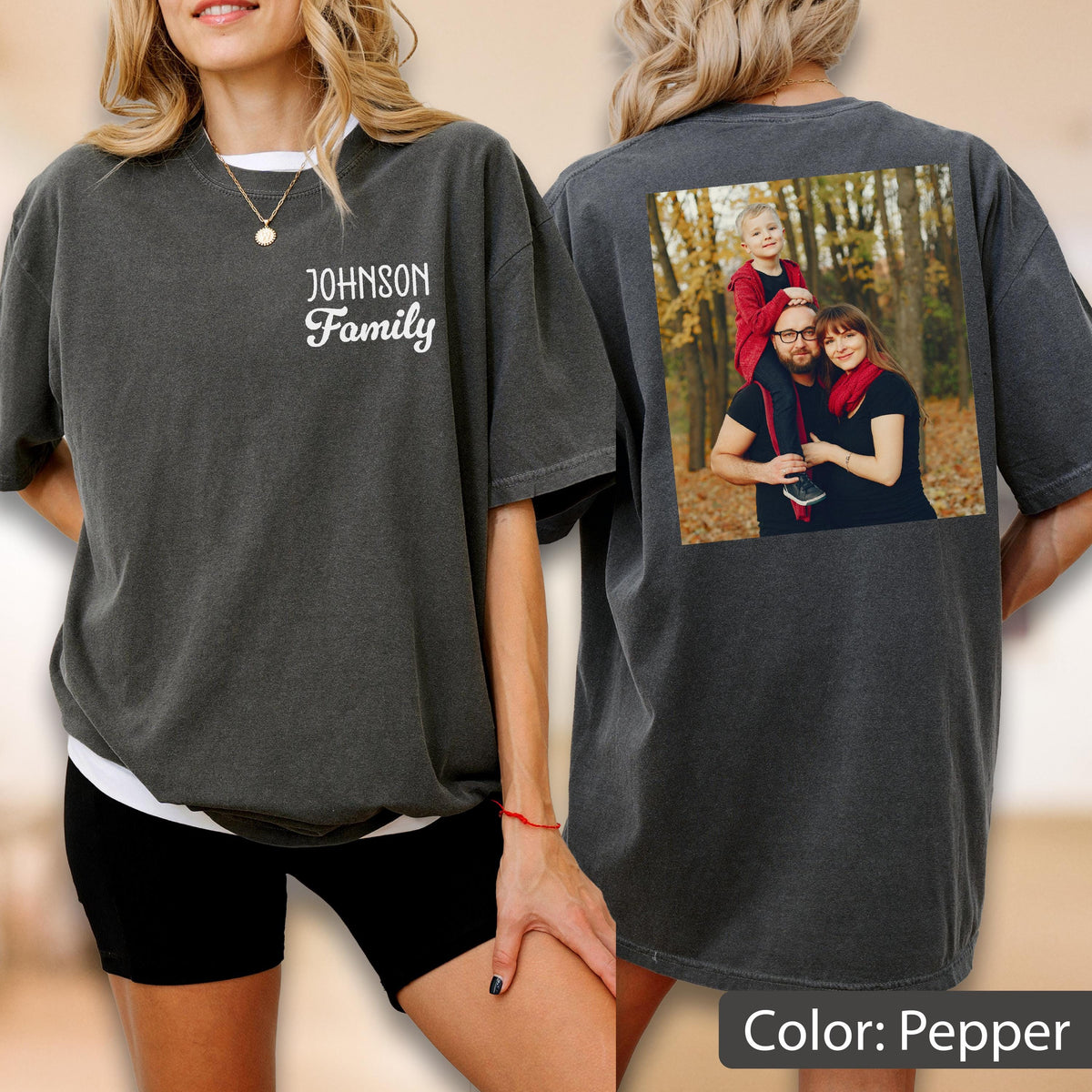 May include: Pepper-colored t-shirt with a family photo on the back and the text "JOHNSON Family" on the front. The photo shows a family of three in a forest setting. The shirt is a relaxed fit.