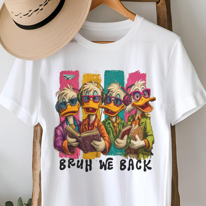May include: White t-shirt featuring a cartoon illustration of four ducks wearing sunglasses and headphones, each holding a book. The ducks are set against colorful vertical stripes. The text "BRUH WE BACK" is printed below the ducks.
