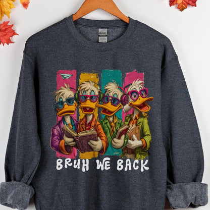 May include: Dark gray sweatshirt featuring a cartoon image of four ducks wearing glasses and holding books. The ducks are dressed in colorful outfits, with the text "BRUH WE BACK" in white below the image.