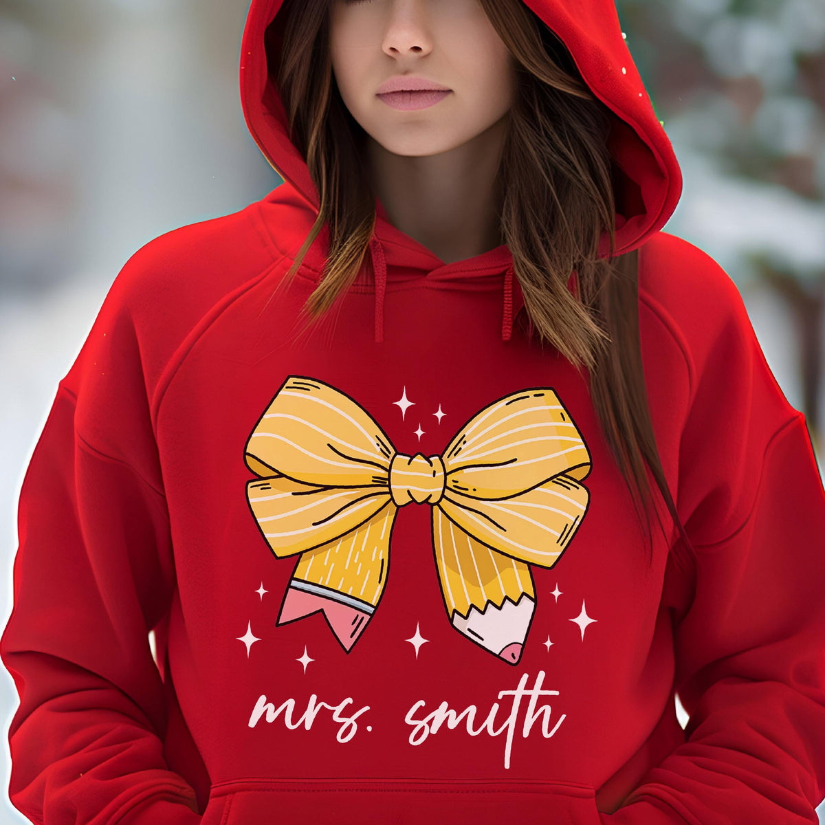 May include: A red hooded sweatshirt featuring a yellow bow design with pencil accents and the name "mrs. smith" in white script. The bow has white stripes and is surrounded by small white star shapes.