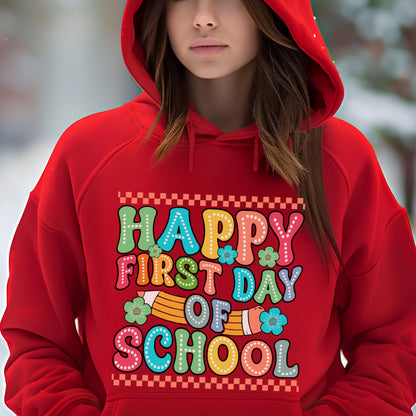 May include: A bright red hooded sweatshirt featuring a graphic print with the text "HAPPY FIRST DAY OF SCHOOL" in colorful, dotted bubble letters. The design includes a yellow pencil illustration and small teal flowers, framed by a checkered border.