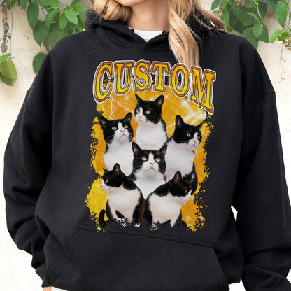 May include: Black hoodie featuring a graphic of six black and white cats on a yellow lightning bolt background. The word "CUSTOM" is printed above the cats in a yellow, distressed font. The hoodie has a drawstring hood and a front pocket.