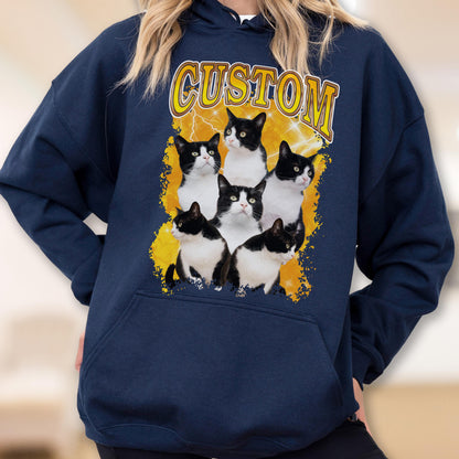 May include: Navy blue hoodie featuring a graphic of six black and white cats with the word "CUSTOM" in yellow text. The cats are arranged on a yellow and white background. The hoodie has a front pocket and a hood.