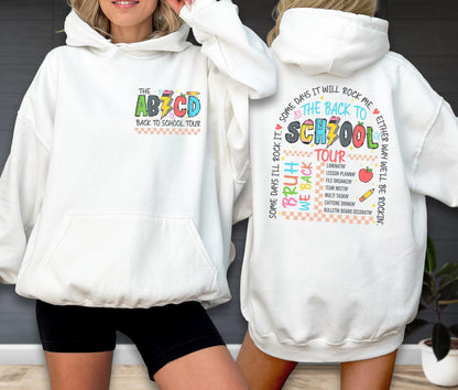 May include: White hoodie with a front pocket and a colorful graphic that says "THE ABCD BACK TO SCHOOL TOUR." The back of the hoodie has a school-themed design with text and images, including "THE BACK TO SCHOOL TOUR."